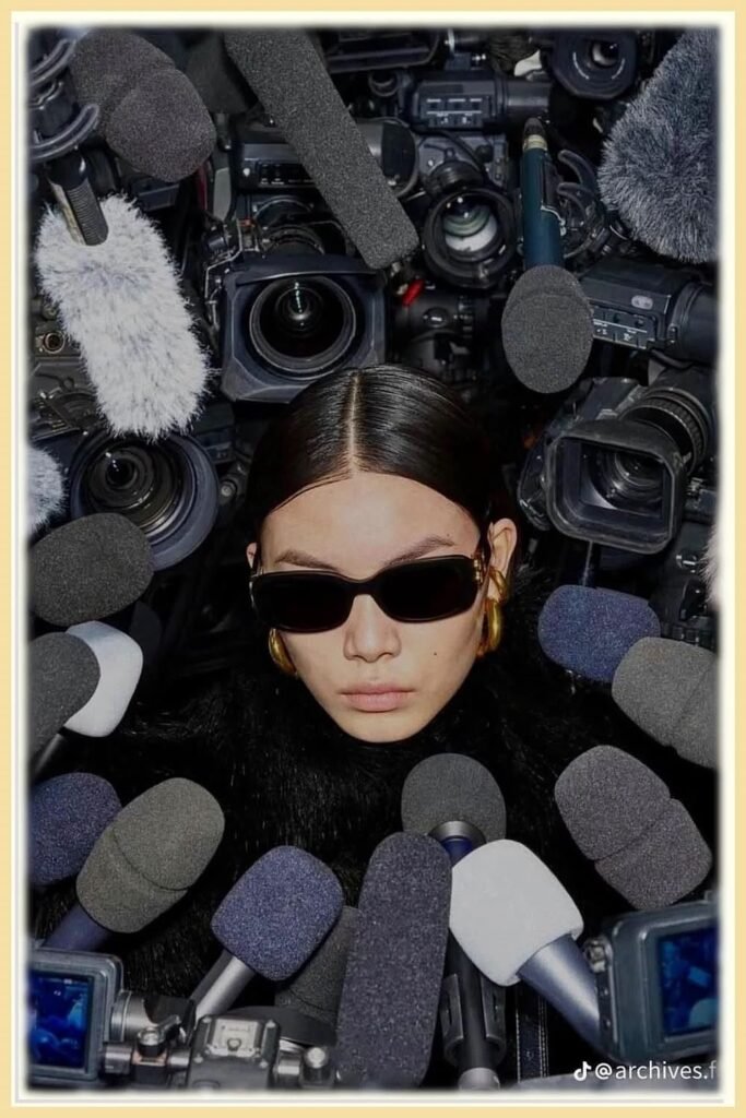 A professional surrounded by cameras and microphones, representing media attention, public relations, digital branding, and online reputation management.